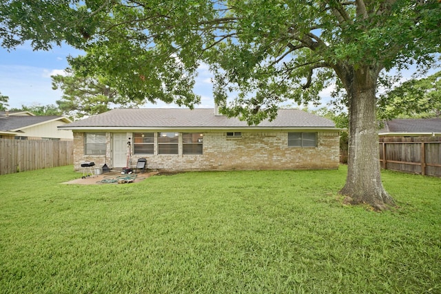 411 Pickford Dr, Katy, TX 77450 - rear view of property featuring a fenced backyard, brick siding, a patio area, and a shingled roof