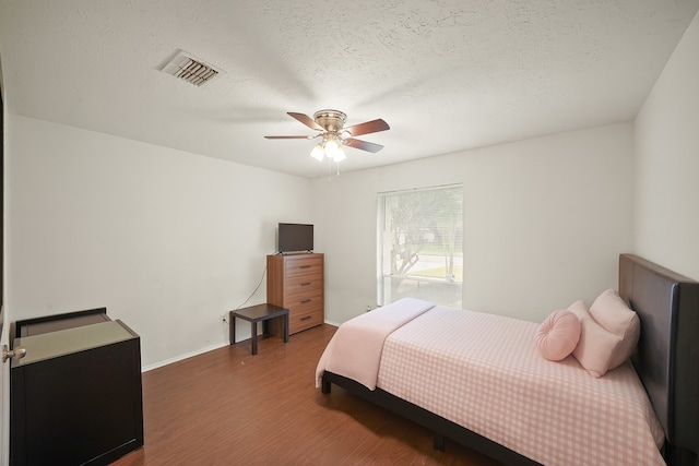 411 Pickford Dr, Katy, TX 77450 - bedroom featuring wood finished floors, ceiling fan, and a textured ceiling
