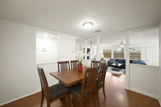 411 Pickford Dr, Katy, TX 77450 - dining room featuring wood finished floors, a textured ceiling, and a ceiling fan