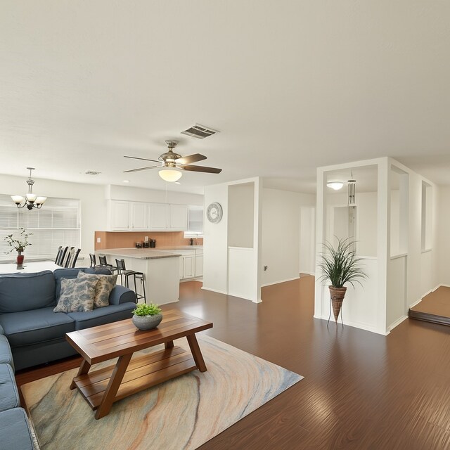 411 Pickford Dr, Katy, TX 77450 - living room featuring wood finished floors, a ceiling fan, and a chandelier