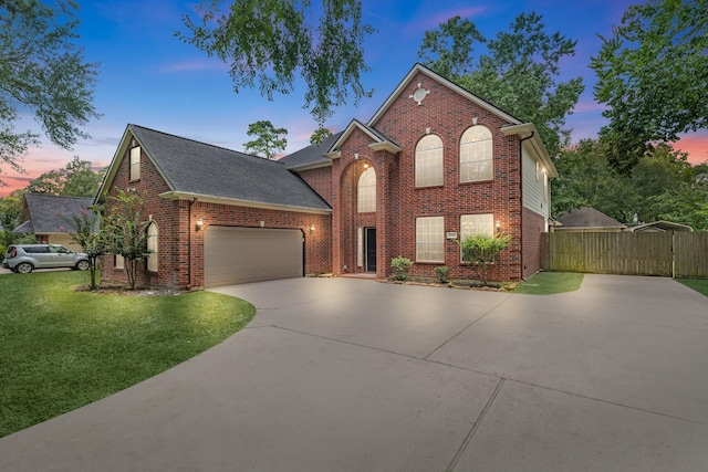 5918 Mahogany Way, Magnolia, TX 77354 - traditional-style home featuring brick siding, driveway, a garage, and a gate