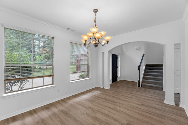 5918 Mahogany Way, Magnolia, TX 77354 - unfurnished dining area featuring a chandelier, arched walkways, stairway, wood finished floors, and ornamental molding