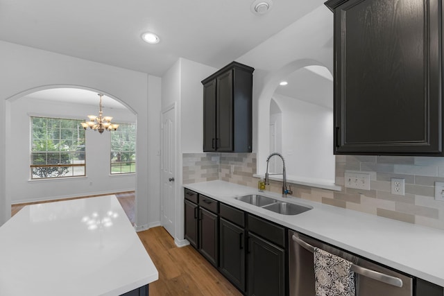 5918 Mahogany Way, Magnolia, TX 77354 - kitchen with dishwasher, light wood-style flooring, light countertops, arched walkways, and recessed lighting