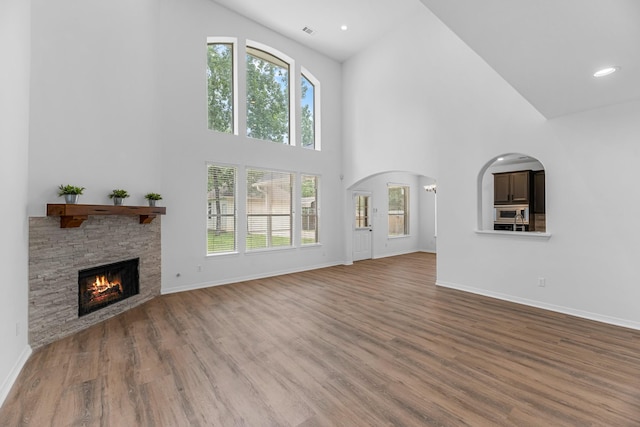 5918 Mahogany Way, Magnolia, TX 77354 - unfurnished living room with high vaulted ceiling, a fireplace, healthy amount of natural light, wood finished floors, and recessed lighting