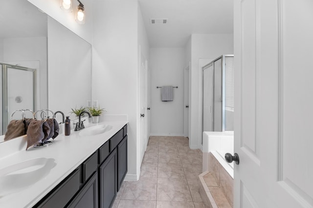 5918 Mahogany Way, Magnolia, TX 77354 - full bathroom featuring a stall shower, double vanity, and a relaxing tiled tub
