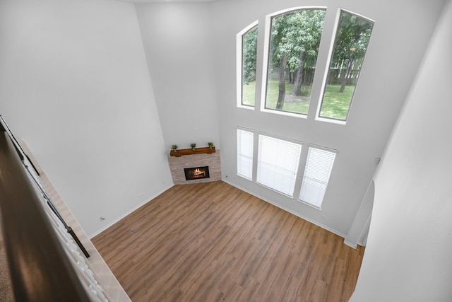 5918 Mahogany Way, Magnolia, TX 77354 - unfurnished living room with a fireplace, wood finished floors, and a high ceiling