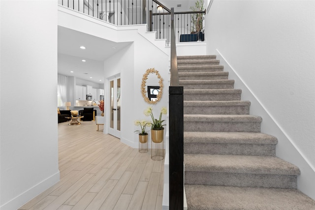17735 Tree Of Heaven, Conroe, TX 77385 - staircase featuring a high ceiling, wood finished floors, and recessed lighting