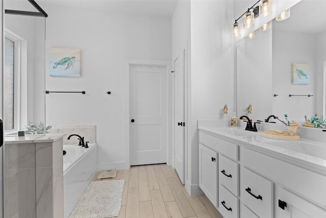17735 Tree Of Heaven, Conroe, TX 77385 - full bathroom featuring double vanity, a garden tub, and wood finished floors