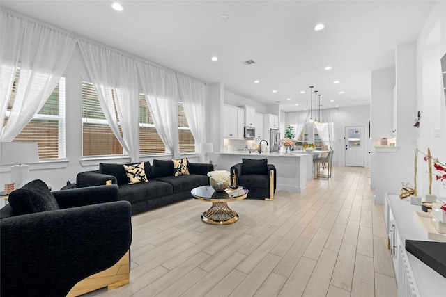 17735 Tree Of Heaven, Conroe, TX 77385 - living area featuring plenty of natural light, light wood-style flooring, and recessed lighting