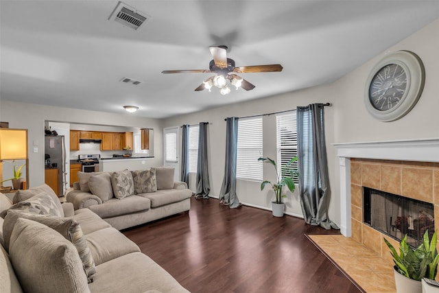 4714 Rumbling Canyon Ct, Katy, TX 77449 - living area featuring a ceiling fan, dark wood-type flooring, and a tile fireplace