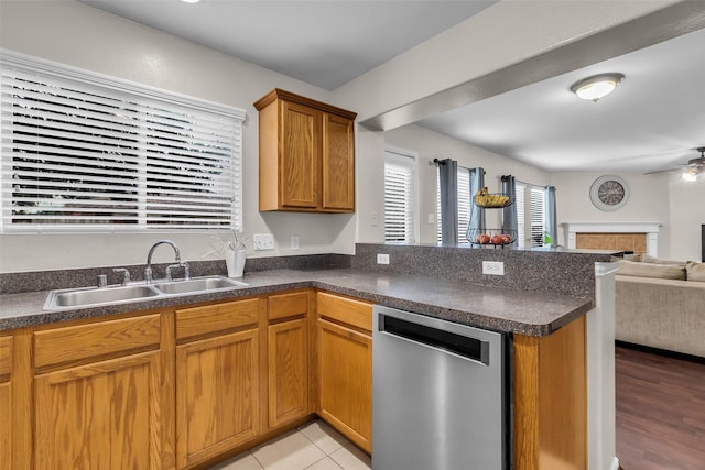4714 Rumbling Canyon Ct, Katy, TX 77449 - kitchen featuring stainless steel dishwasher, open floor plan, a peninsula, a ceiling fan, and dark countertops