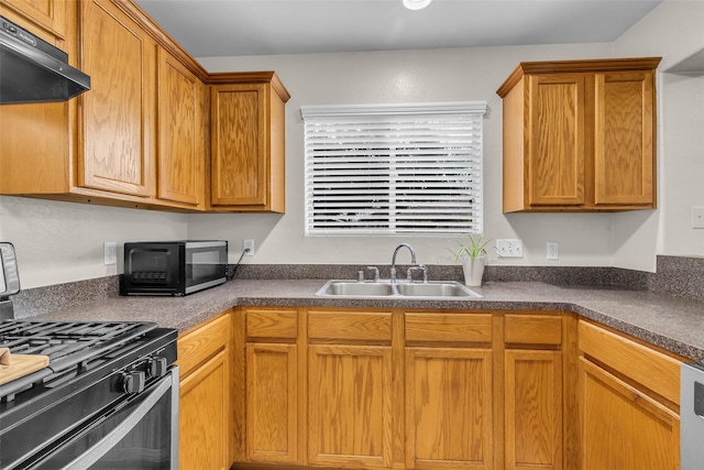 4714 Rumbling Canyon Ct, Katy, TX 77449 - kitchen with under cabinet range hood, black appliances, and dark countertops
