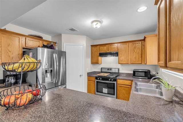 4714 Rumbling Canyon Ct, Katy, TX 77449 - kitchen featuring stainless steel appliances, under cabinet range hood, dark countertops, and a peninsula