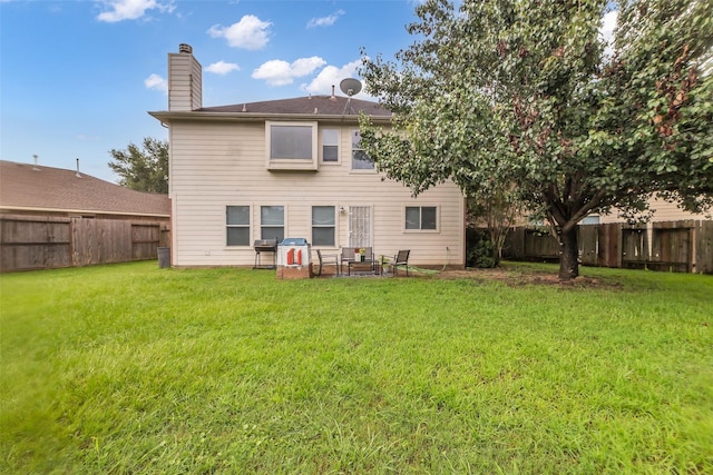 4714 Rumbling Canyon Ct, Katy, TX 77449 - rear view of house featuring a fenced backyard, a chimney, and a patio area