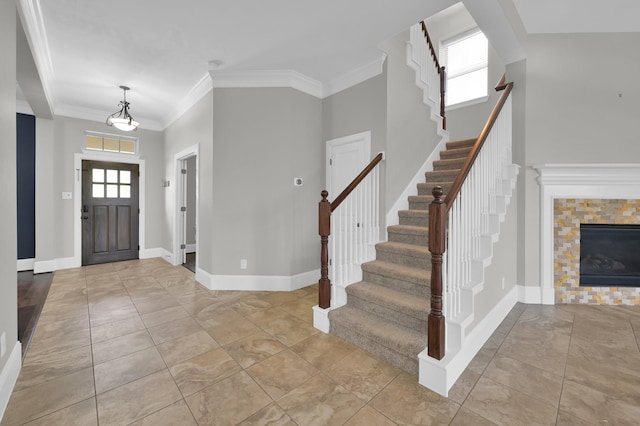 18618 Bridle Grove Ct, Tomball, TX 77377 - entryway with stairs, crown molding, and a tiled fireplace