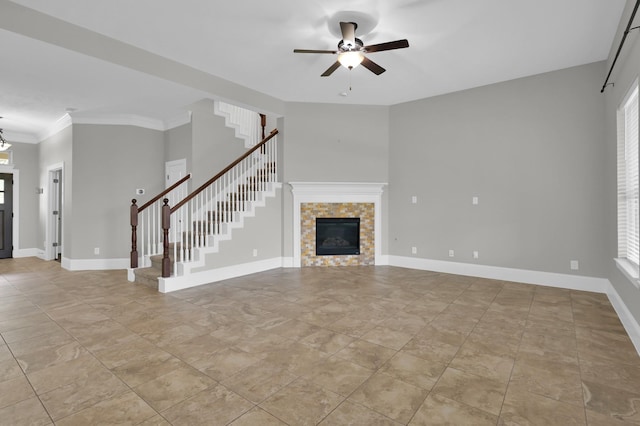 18618 Bridle Grove Ct, Tomball, TX 77377 - unfurnished living room featuring stairs, ceiling fan, a tiled fireplace, healthy amount of natural light, and ornamental molding