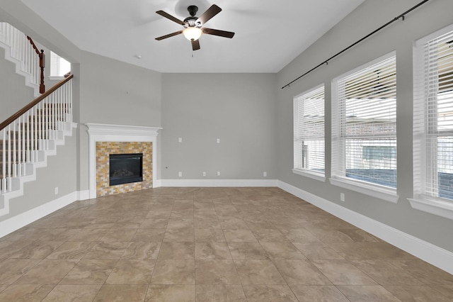18618 Bridle Grove Ct, Tomball, TX 77377 - unfurnished living room with ceiling fan, stairs, light tile patterned floors, and a tiled fireplace