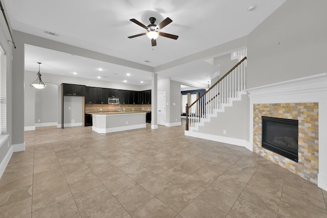 18618 Bridle Grove Ct, Tomball, TX 77377 - unfurnished living room featuring ceiling fan, a fireplace, recessed lighting, light tile patterned floors, and stairway