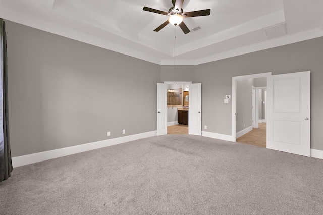 18618 Bridle Grove Ct, Tomball, TX 77377 - unfurnished bedroom featuring a raised ceiling, light carpet, ensuite bathroom, and a ceiling fan