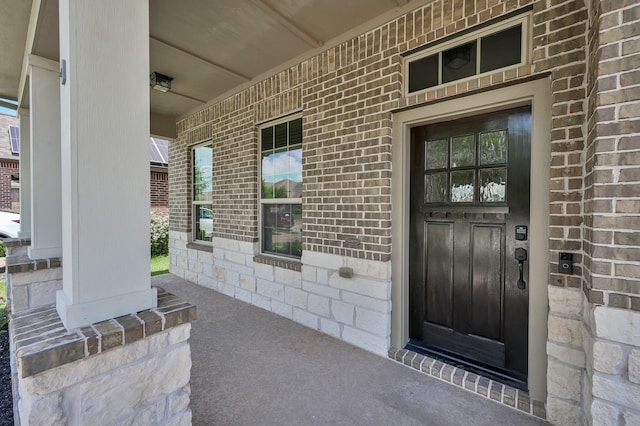 18618 Bridle Grove Ct, Tomball, TX 77377 - view of exterior entry featuring covered porch, brick siding, and stone siding