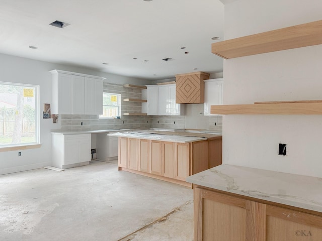 10651 Mayfield Rd, Houston, TX 77043 - kitchen featuring open shelves, decorative backsplash, and concrete floors