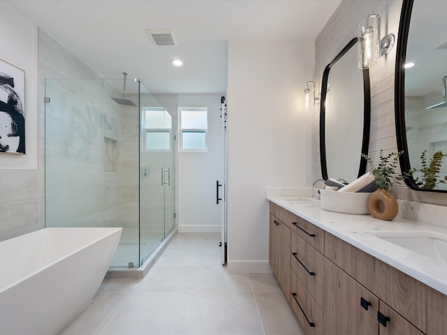10651 Mayfield Rd, Houston, TX 77043 - bathroom with a stall shower, double vanity, a freestanding bath, tile patterned flooring, and recessed lighting