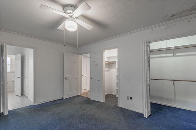 3799 Summer Ln, Huntsville, TX 77340 - unfurnished bedroom with carpet flooring, connected bathroom, ornamental molding, a ceiling fan, and multiple closets