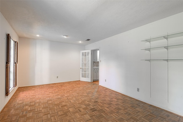 3799 Summer Ln, Huntsville, TX 77340 - unfurnished room featuring a textured ceiling, recessed lighting, and french doors