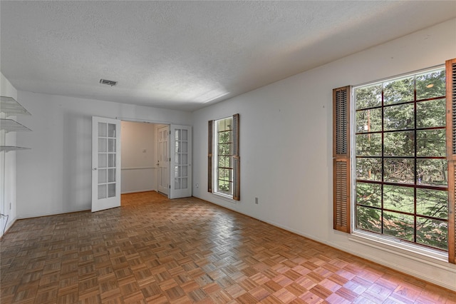 3799 Summer Ln, Huntsville, TX 77340 - spare room featuring french doors and a textured ceiling