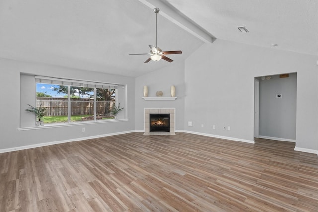 14306 Cypress Meadow Dr, Cypress, TX 77429 - unfurnished living room featuring ceiling fan, wood finished floors, and a tile fireplace