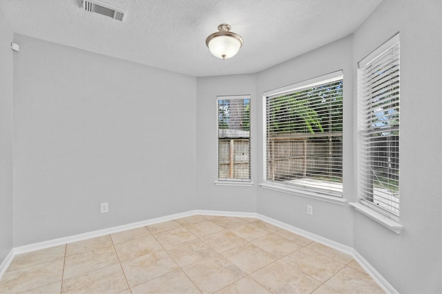 14306 Cypress Meadow Dr, Cypress, TX 77429 - tiled spare room featuring a textured ceiling and baseboards