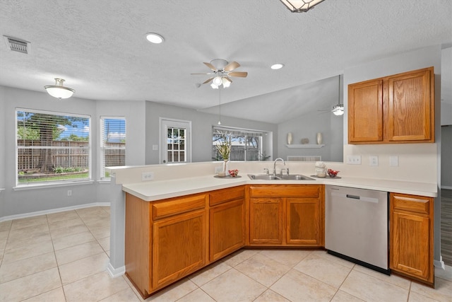 14306 Cypress Meadow Dr, Cypress, TX 77429 - kitchen featuring stainless steel dishwasher, ceiling fan, a peninsula, light countertops, and brown cabinets