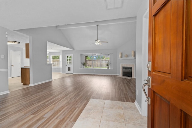 14306 Cypress Meadow Dr, Cypress, TX 77429 - unfurnished living room with a ceiling fan, a tiled fireplace, light wood-style flooring, and lofted ceiling