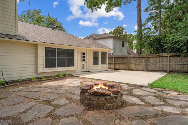14306 Cypress Meadow Dr, Cypress, TX 77429 - back of property with a patio area, a fire pit, and a shingled roof