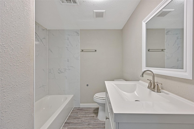 2131 6th Ave N, Texas City, TX 77590 - full bath featuring vanity, wood finished floors, a textured ceiling, and shower / bath combination
