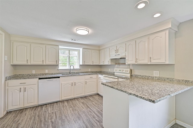 2131 6th Ave N, Texas City, TX 77590 - kitchen with white appliances, a peninsula, under cabinet range hood, light wood finished floors, and light stone counters