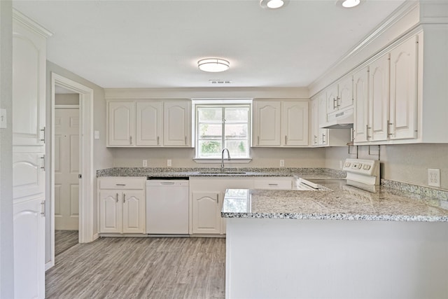2131 6th Ave N, Texas City, TX 77590 - kitchen featuring white appliances, under cabinet range hood, a peninsula, light stone counters, and light wood-type flooring