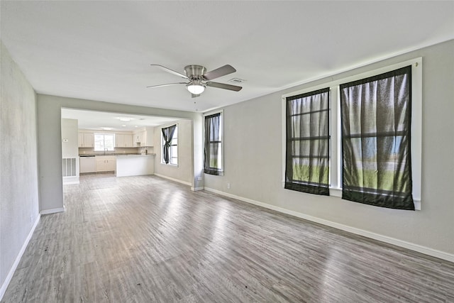 2131 6th Ave N, Texas City, TX 77590 - unfurnished living room featuring wood finished floors and ceiling fan