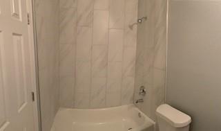 327 Delaware St Unit A, Houston, TX 77029 - full bathroom featuring toilet and bathtub / shower combination