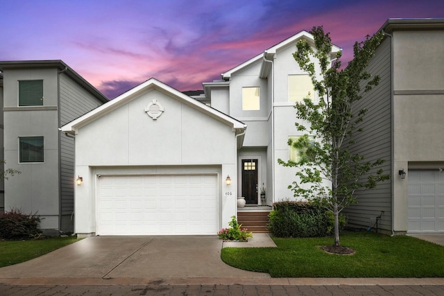 406 Yale Oaks Ln, Houston, TX 77091 - view of front facade with an attached garage, concrete driveway, stucco siding, and a yard