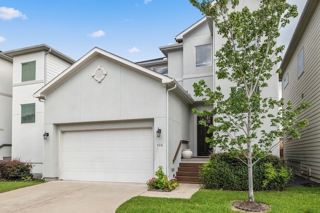 406 Yale Oaks Ln, Houston, TX 77091 - view of front of house with concrete driveway, stucco siding, and an attached garage