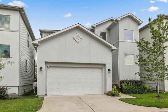 406 Yale Oaks Ln, Houston, TX 77091 - view of front of home featuring driveway, stucco siding, and a garage