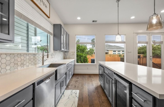 406 Yale Oaks Ln, Houston, TX 77091 - kitchen featuring stainless steel dishwasher, beverage cooler, gray cabinets, dark wood-type flooring, and light countertops