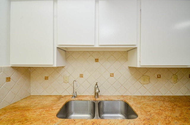 2100 Tanglewilde St Unit 169, Houston, TX 77063 - kitchen featuring white cabinetry, decorative backsplash, and light stone countertops