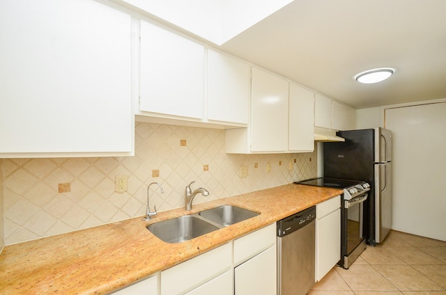 2100 Tanglewilde St Unit 169, Houston, TX 77063 - kitchen featuring appliances with stainless steel finishes, under cabinet range hood, backsplash, white cabinetry, and light tile patterned floors
