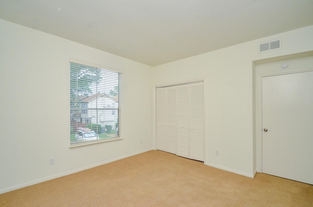 2100 Tanglewilde St Unit 169, Houston, TX 77063 - unfurnished bedroom featuring light colored carpet and a closet