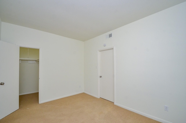 2100 Tanglewilde St Unit 169, Houston, TX 77063 - unfurnished bedroom featuring light carpet, a spacious closet, and a closet
