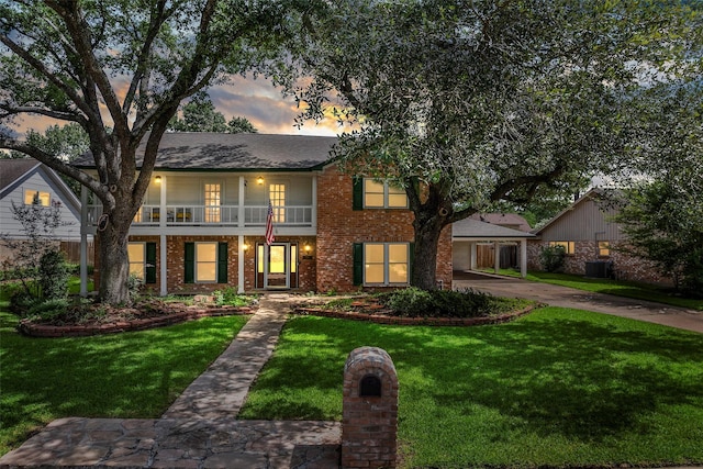 8114 Coolshire Ln, Houston, TX 77070 - view of front of house with a balcony, brick siding, a front lawn, and driveway