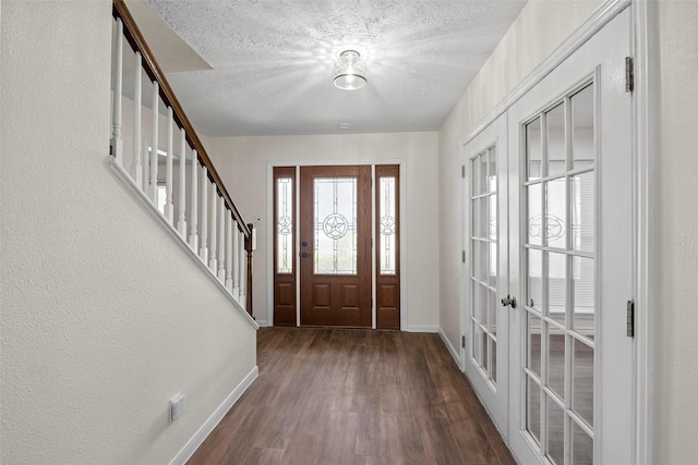 8114 Coolshire Ln, Houston, TX 77070 - entrance foyer featuring french doors, wood finished floors, stairway, and a textured ceiling