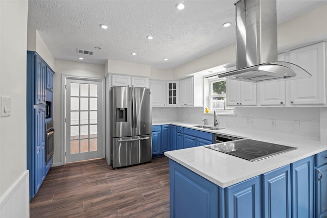 8114 Coolshire Ln, Houston, TX 77070 - kitchen featuring stainless steel appliances, blue cabinetry, island exhaust hood, a peninsula, and dark wood-style floors